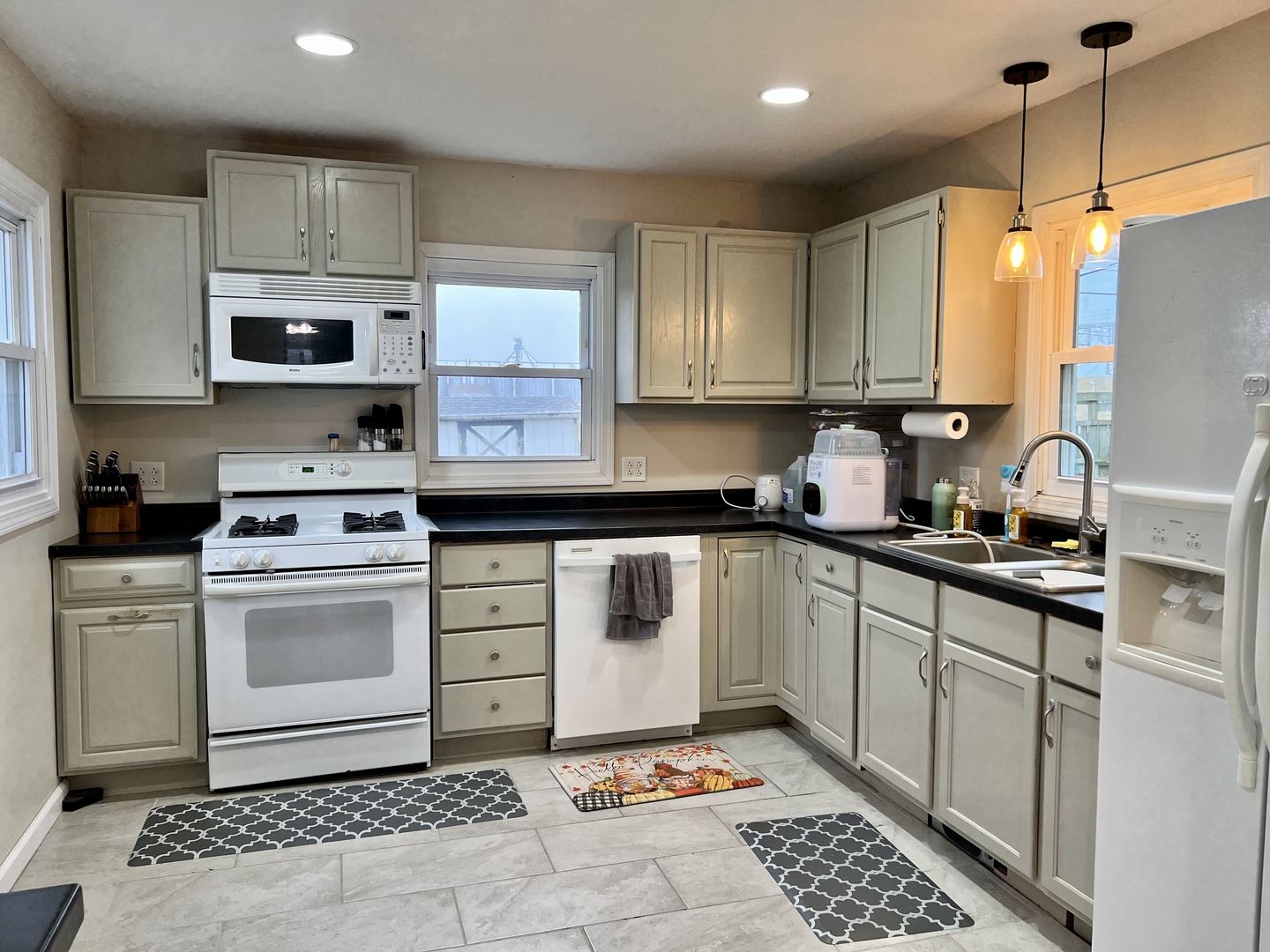 113 Walnut Street Gibson City, IL 60936 - Photo 14 of 33 a kitchen with a white stove top oven and cabinets