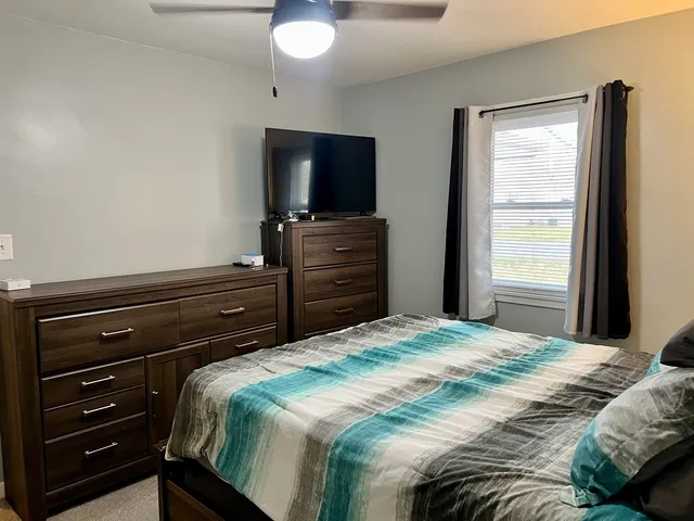 a bedroom with a bed and a television