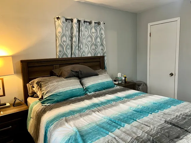 a bedroom with a bed and window