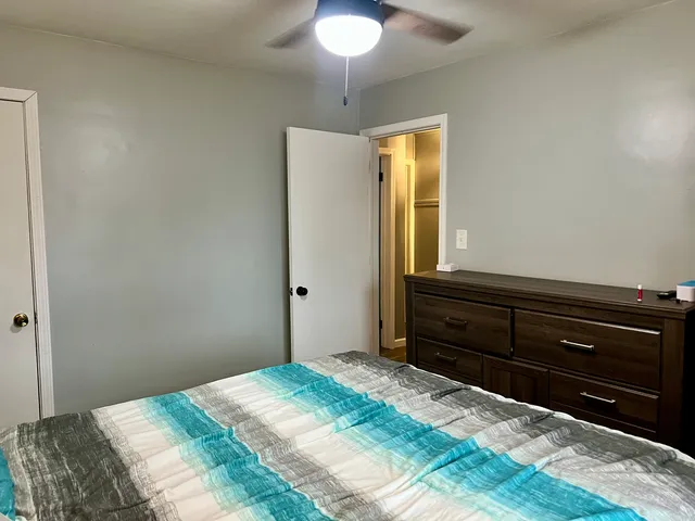 a bedroom with a bed and a chandelier