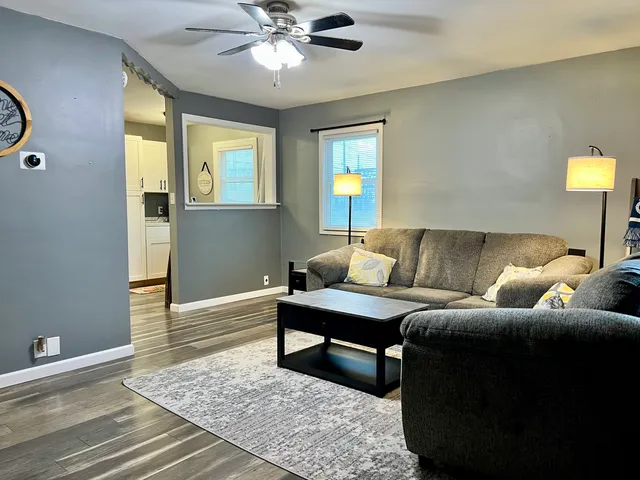 a living room with a couch and a chandelier