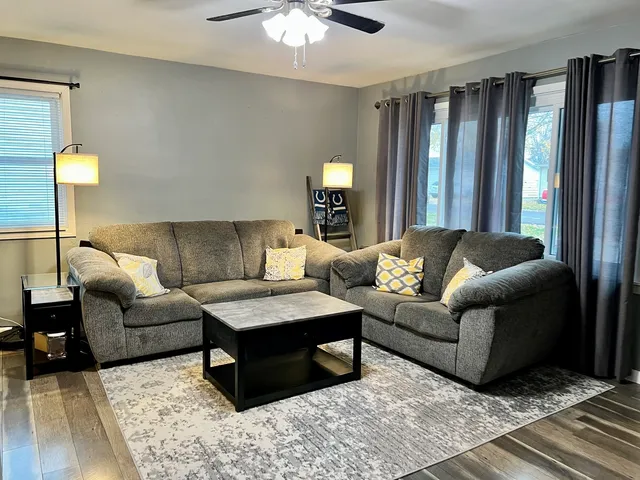 a living room with furniture and a lamp