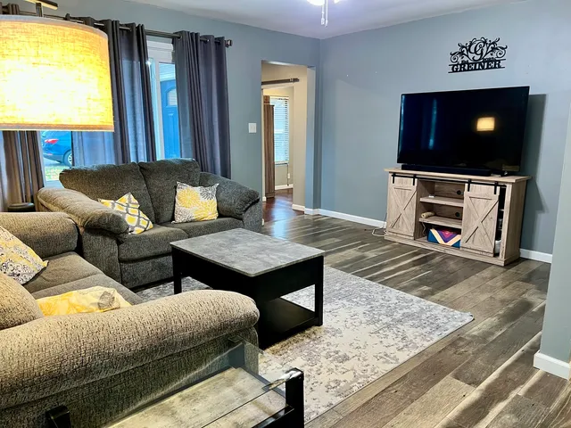 a living room with furniture and a flat screen tv