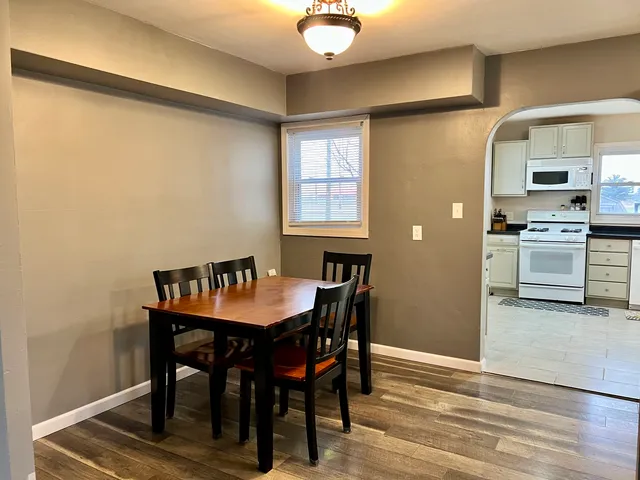 a view of a dining room with furniture and wooden floor