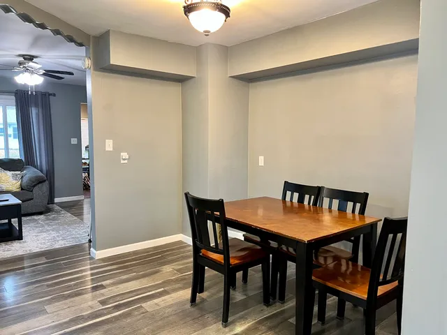 a view of a dining room with furniture and wooden floor