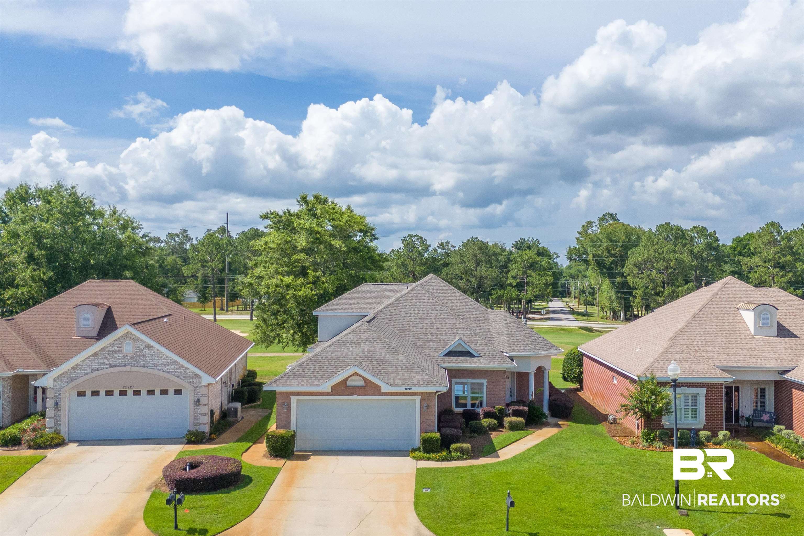 22739 Inverness Way Foley, AL 36535 - Photo 61 of 80 View of front of home featuring a front yard, driveway, brick siding, and a garage