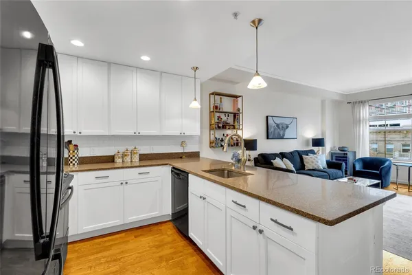 a kitchen with a sink window and cabinets