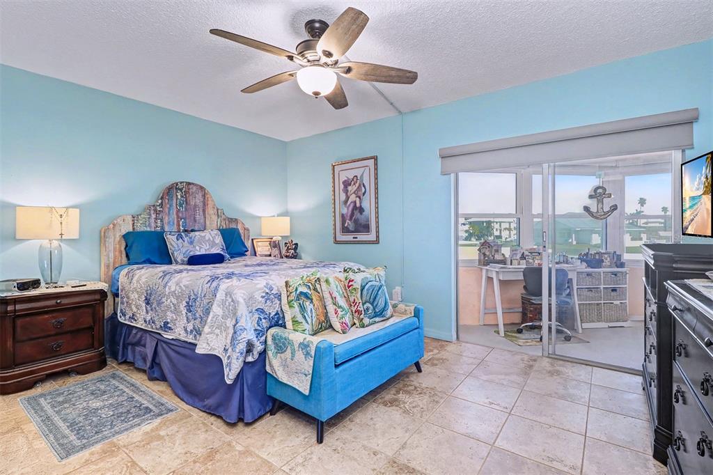 17400 Gulf Boulevard, Unit H2 Redington Shores, FL 33708 - Photo 19 of 36 a spacious bedroom with a large bed and a chandelier