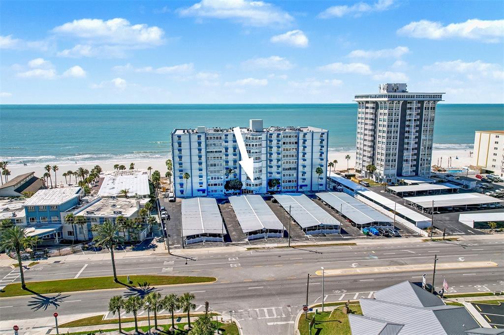 17400 Gulf Boulevard, Unit H2 Redington Shores, FL 33708 - Photo 33 of 36 a view of building with yard and ocean view in the background