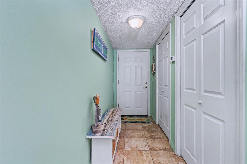 17400 Gulf Boulevard, Unit H2 Redington Shores, FL 33708 - Photo 5 of 36 a view of a hallway with wooden walls and stairs