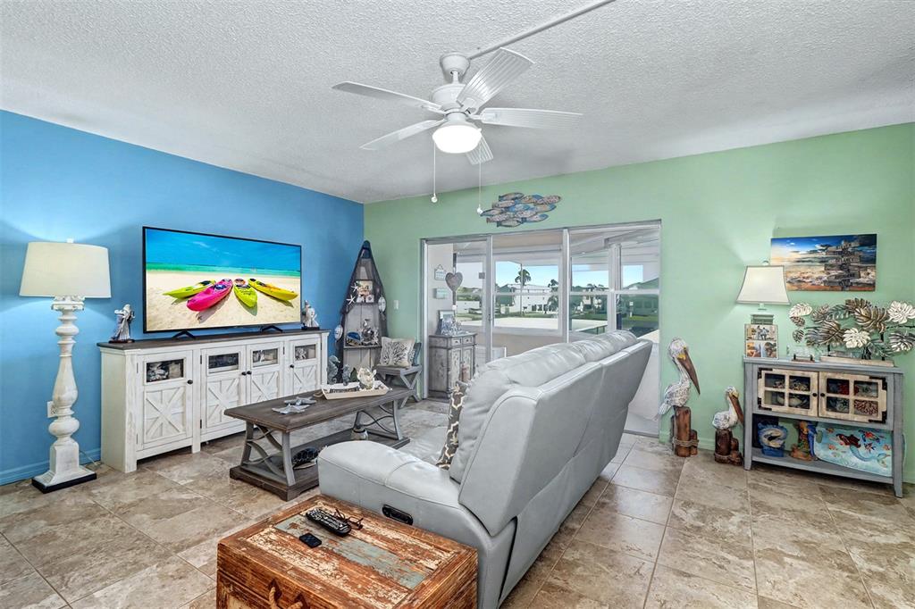 17400 Gulf Boulevard, Unit H2 Redington Shores, FL 33708 - Photo 7 of 36 a living room with furniture and a flat screen tv