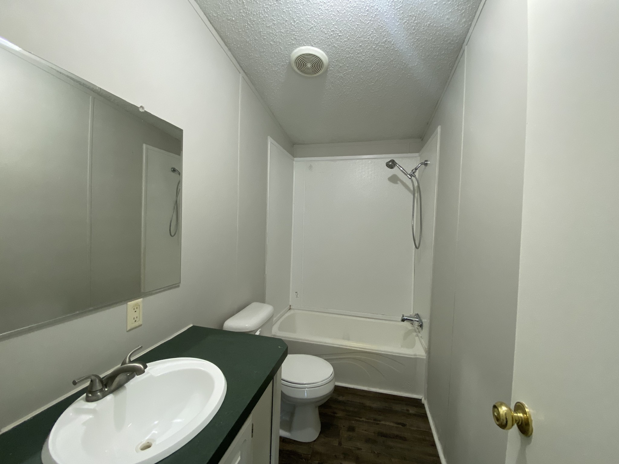 8505 Highway 41 Adams, TN 37010 - Photo 12 of 14 a bathroom with a granite countertop toilet a sink and shower