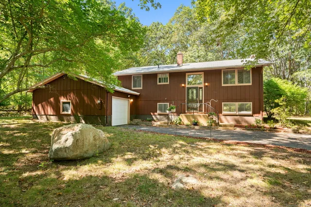 a front view of a house with a garden