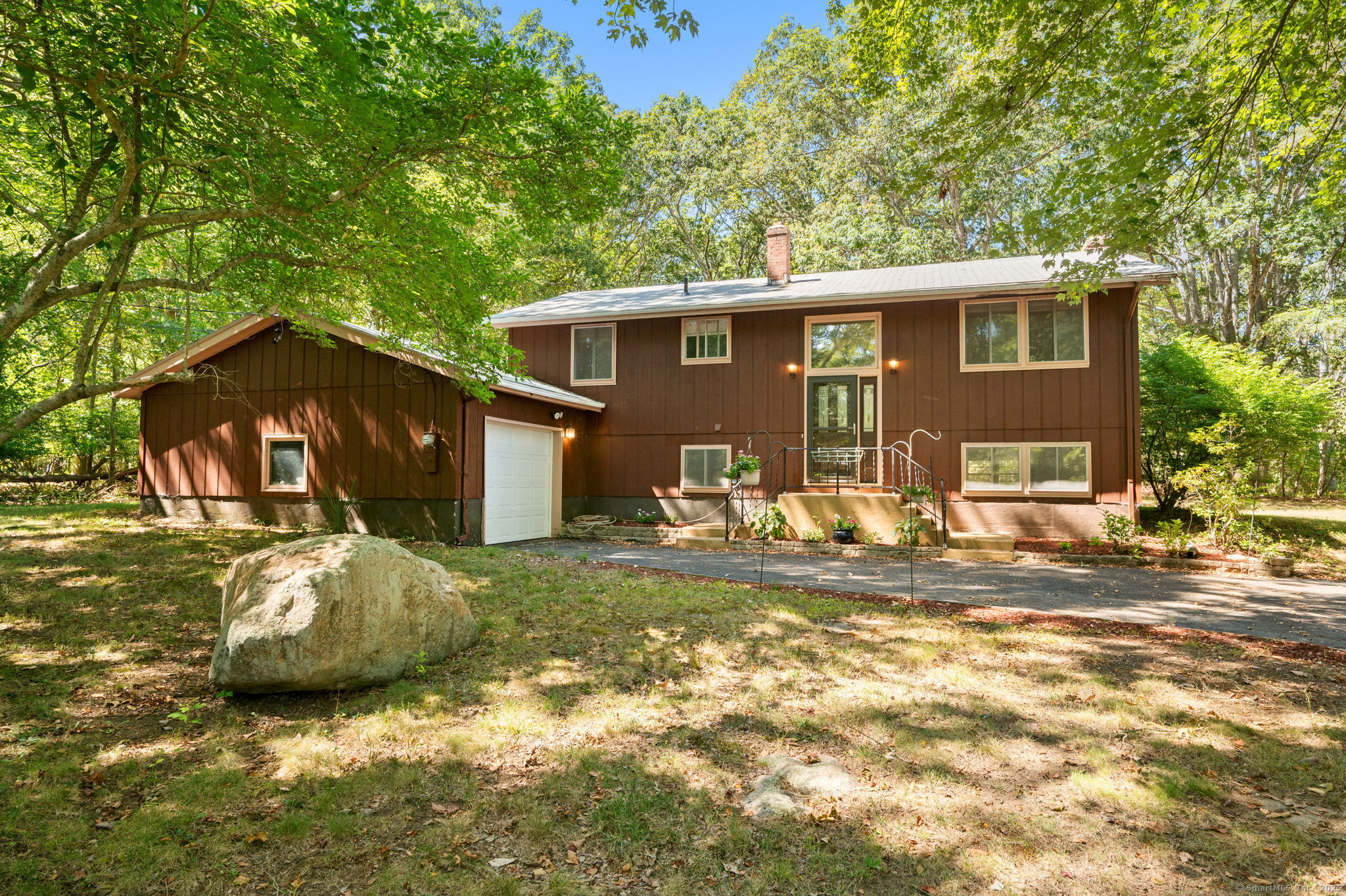 a front view of a house with a garden