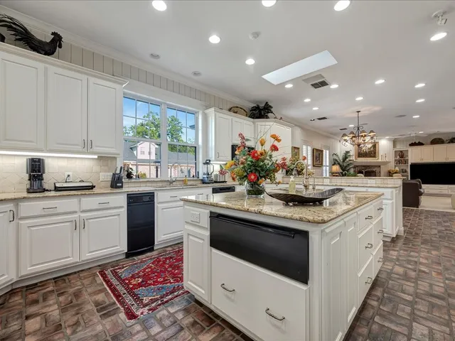a kitchen with a sink stove and cabinets