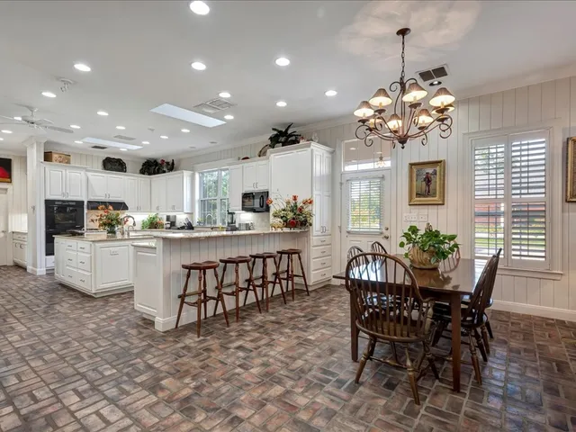 a view of a dining room with furniture and chandelier