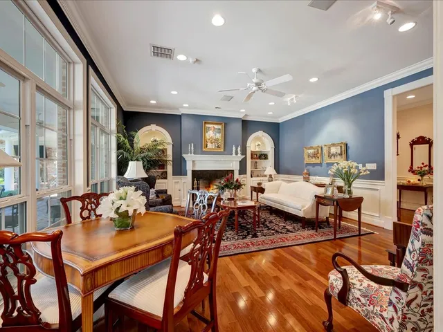 a living room with fireplace furniture and a large window
