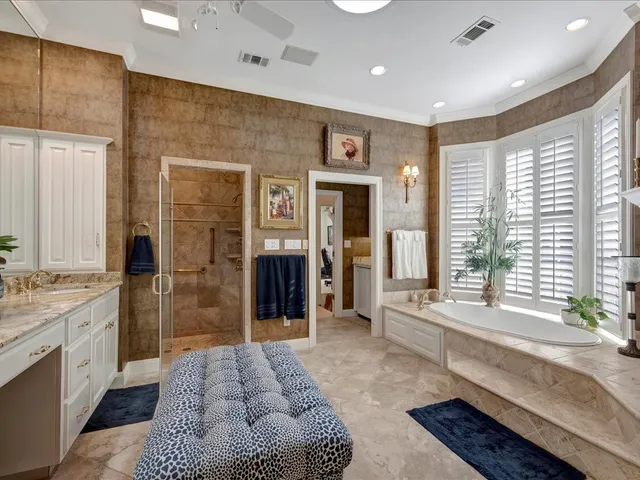 a spacious bathroom with a double vanity sink and a bathtub