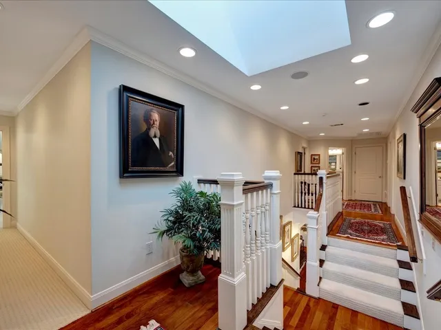 a view of a hallway with wooden floor and entryway