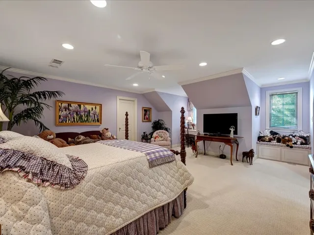a bedroom with furniture and a flat screen tv