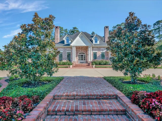 a front view of house with yard and green space