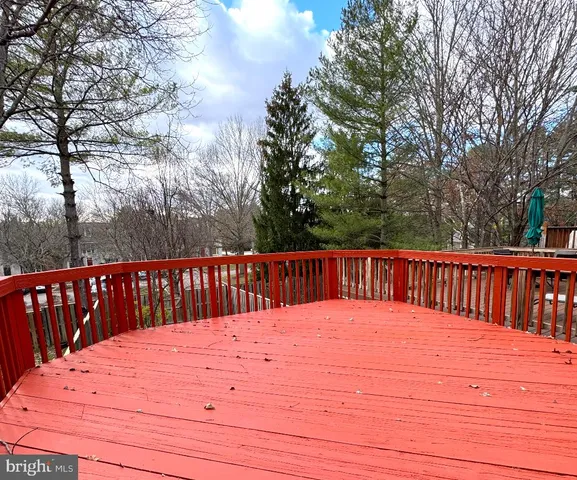 a view of balcony with wooden floor and fence