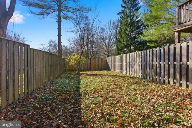 a view of a house with wooden fence