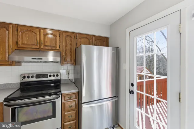 a kitchen with appliances cabinets and a window