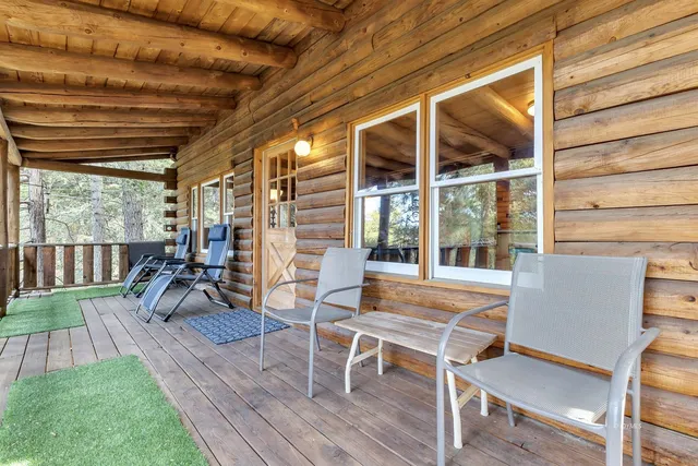 a bedroom with a bed and large windows