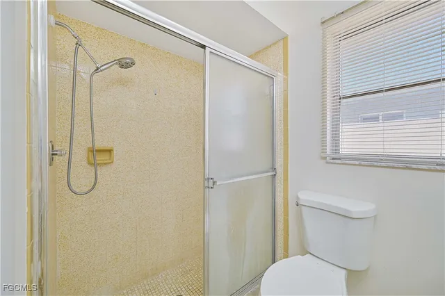 a bathroom with a toilet and a shower