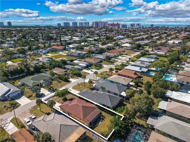 an aerial view of residential houses with city view