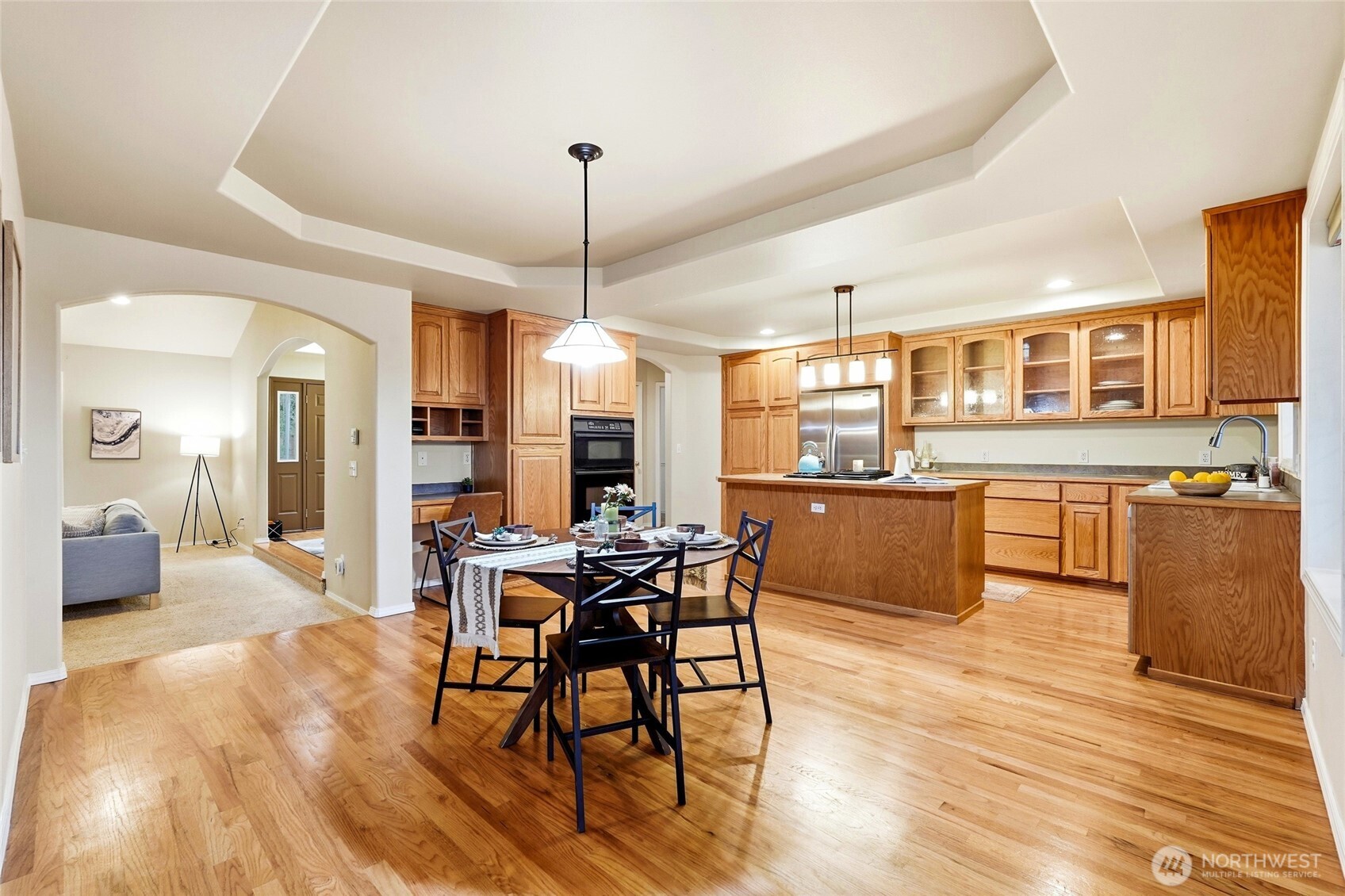 1026 McRae Road Northwest Arlington, WA 98223 - Photo 13 of 40 a view of a dining room and livingroom with furniture wooden floor a chandelier