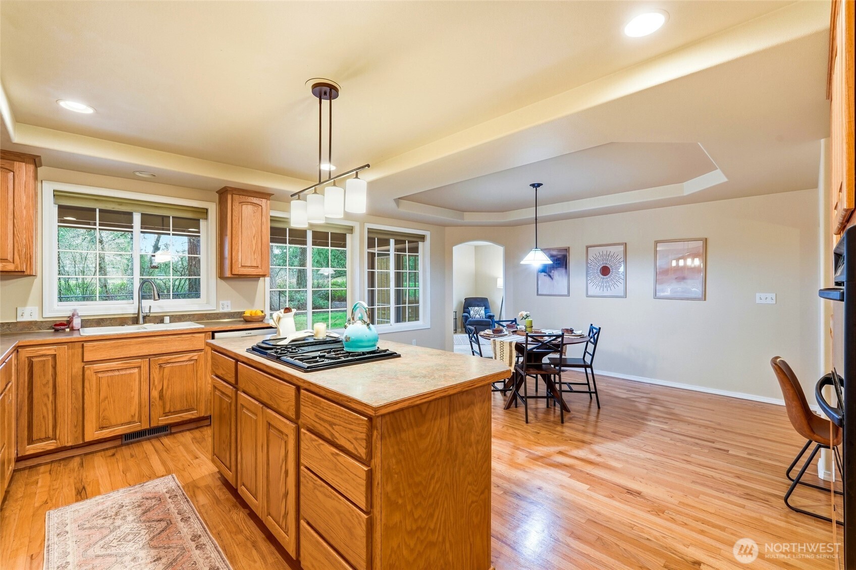 1026 McRae Road Northwest Arlington, WA 98223 - Photo 14 of 40 a kitchen that has a table chairs in it and wooden floors