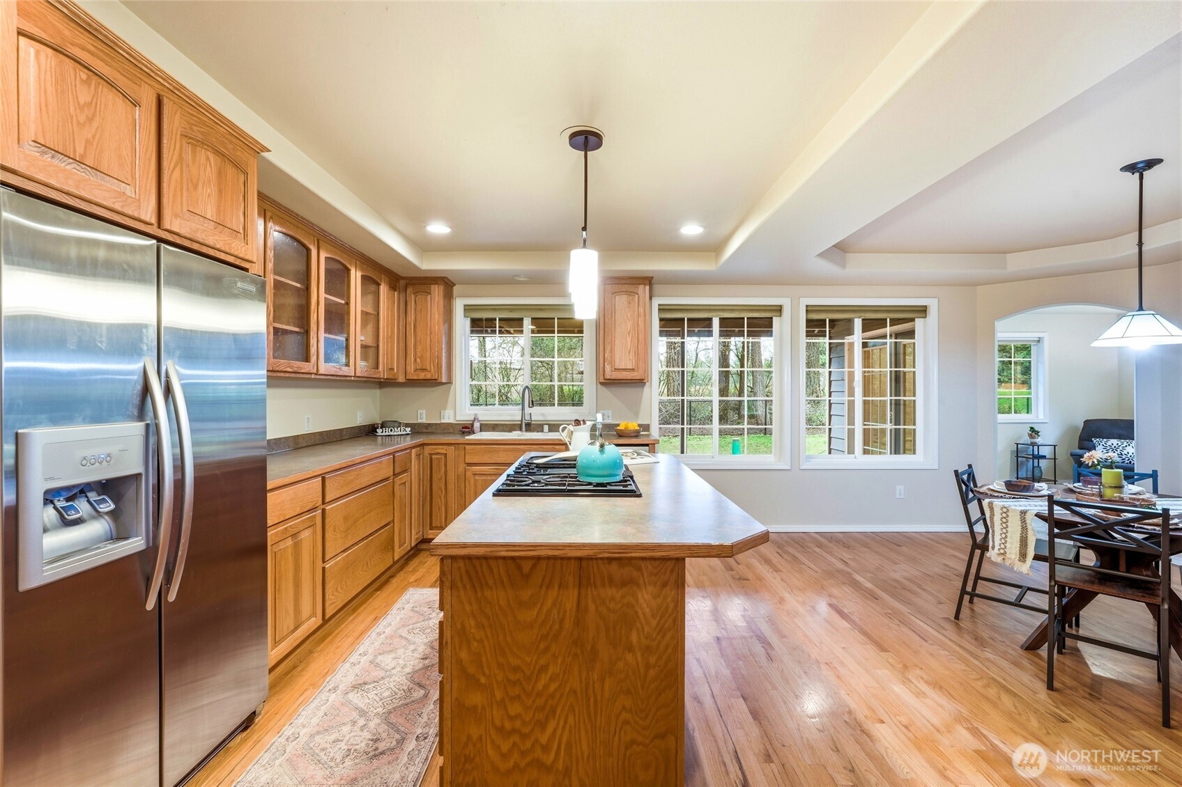 1026 McRae Road Northwest Arlington, WA 98223 - Photo 16 of 40 a large kitchen with sink a refrigerator and chairs