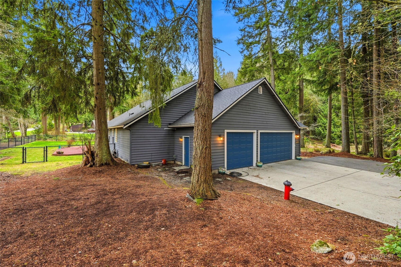 1026 McRae Road Northwest Arlington, WA 98223 - Photo 2 of 40 a front view of a house with a yard and garage