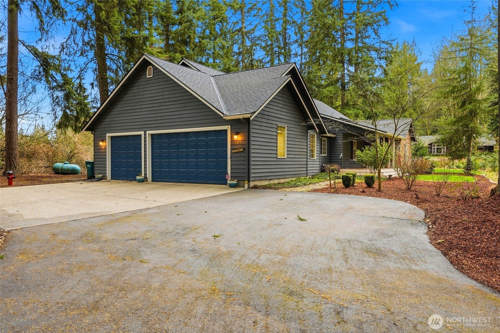 1026 McRae Road Northwest Arlington, WA 98223 - Photo 31 of 40 a view of a house with a yard and garage