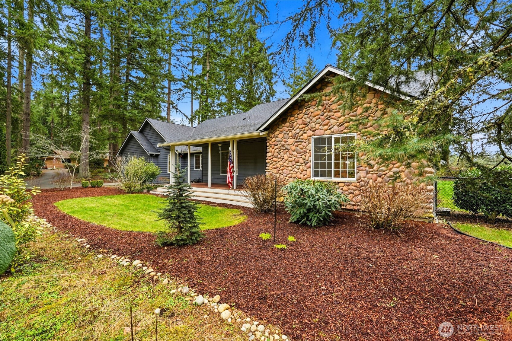 1026 McRae Road Northwest Arlington, WA 98223 - Photo 33 of 40 a front view of a house with garden