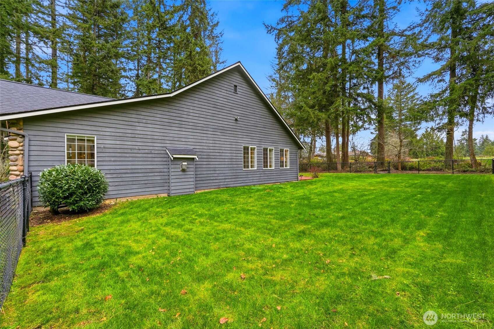 1026 McRae Road Northwest Arlington, WA 98223 - Photo 38 of 40 a view of a backyard with plants and large tree