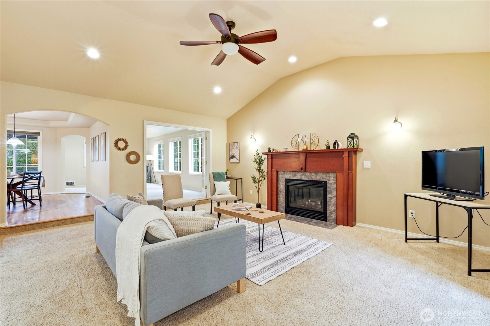 1026 McRae Road Northwest Arlington, WA 98223 - Photo 7 of 40 a living room with furniture a fireplace and a flat screen tv