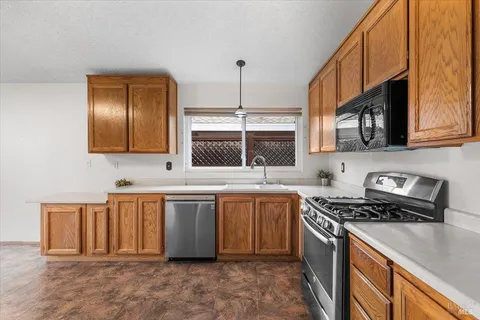 an empty room with a ceiling fan and window