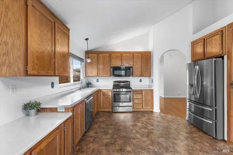 a bathroom with a granite countertop sink a toilet and mirror