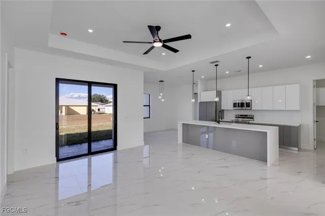 a kitchen with stainless steel appliances a refrigerator sink and cabinets