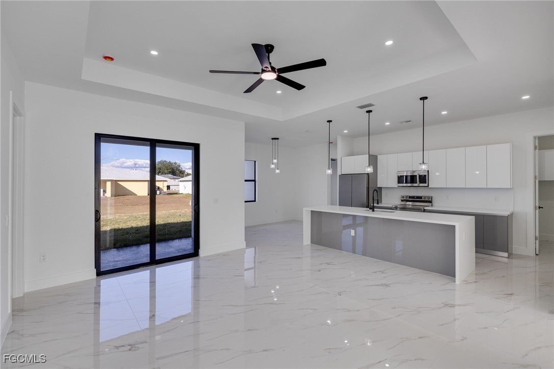 2506 36th Street Southwest Lehigh Acres, FL 33976 - Photo 11 of 25 a kitchen with stainless steel appliances a refrigerator sink and cabinets