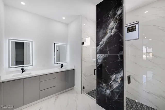 a bathroom with double vanity and a shower