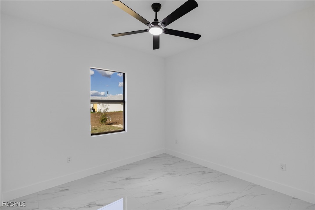 2506 36th Street Southwest Lehigh Acres, FL 33976 - Photo 17 of 25 an empty room with a window and a ceiling fan