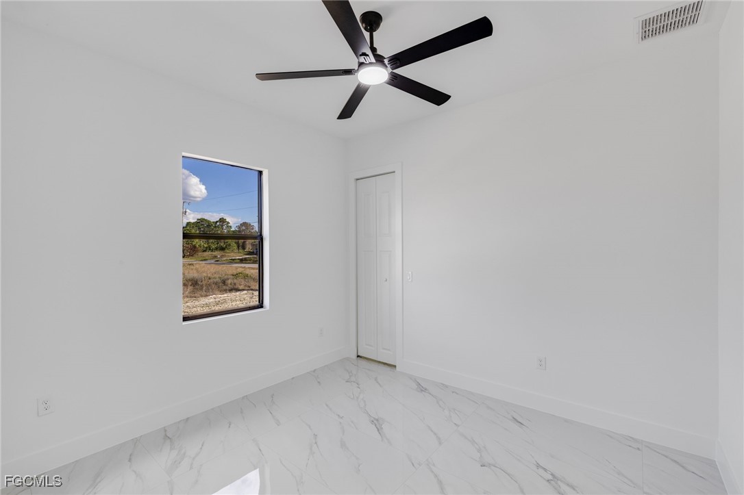 2506 36th Street Southwest Lehigh Acres, FL 33976 - Photo 18 of 25 an empty room with a window and a fan