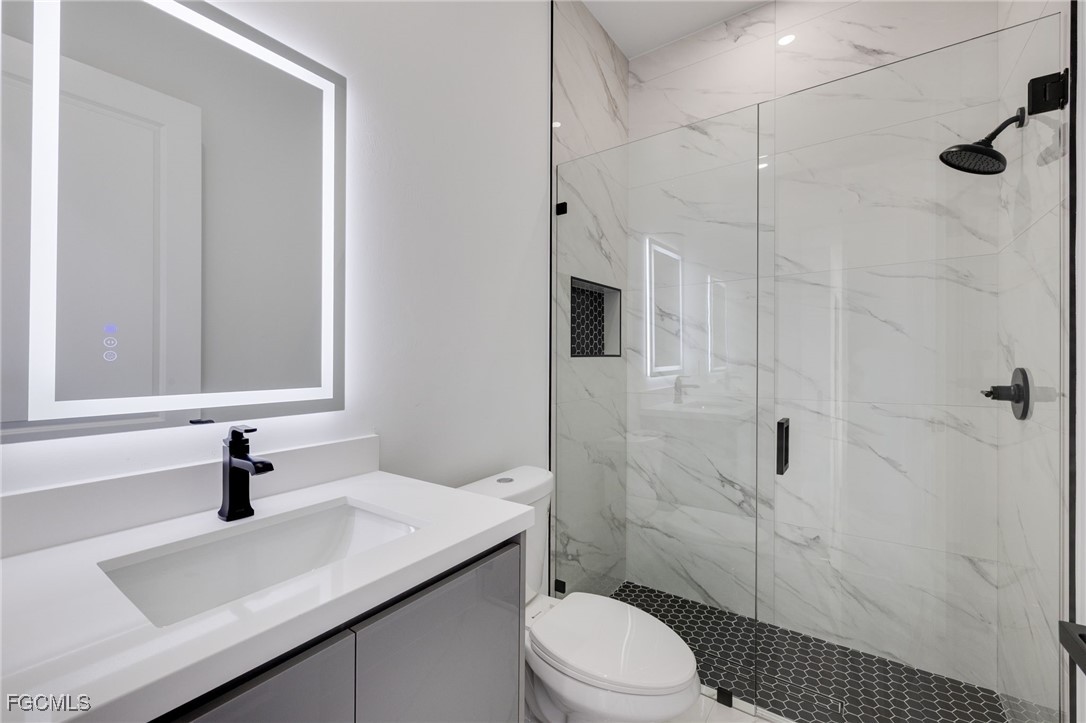 2506 36th Street Southwest Lehigh Acres, FL 33976 - Photo 19 of 25 a bathroom with a sink a toilet and shower