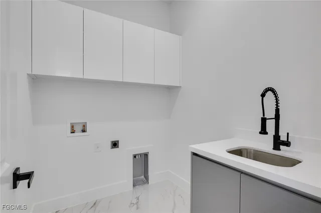 a close view of a sink a faucet and cabinets