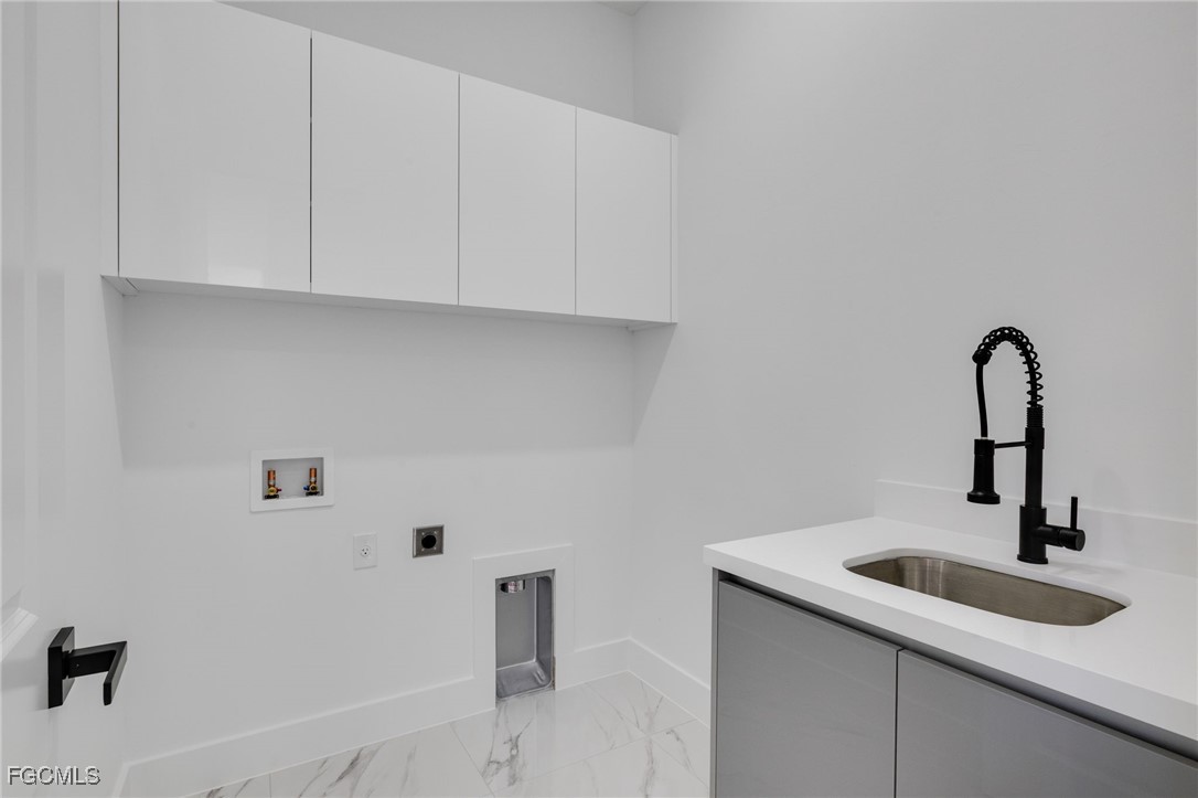 2506 36th Street Southwest Lehigh Acres, FL 33976 - Photo 20 of 25 a close view of a sink a faucet and cabinets