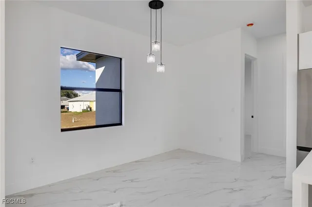 a view of a hallway with paintings on the wall